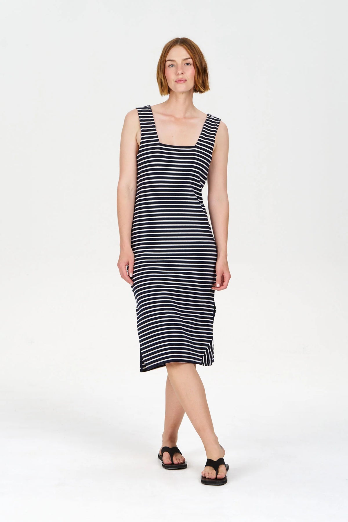 Woman wearing a black and white striped dress on a white background