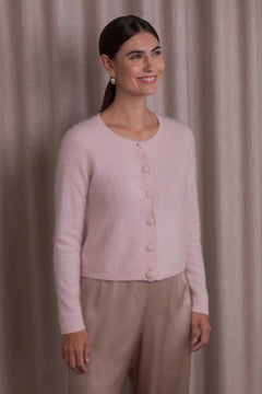 Woman wearing Original Story pale pink cashmere cardigan