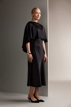 Woman wearing Original Story black satin cape top