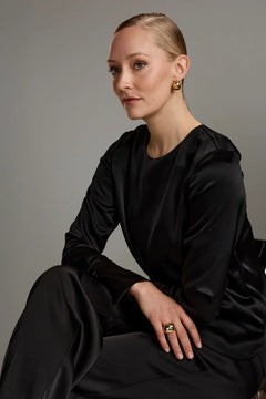 Woman wearing Original Story black long sleeve blouse