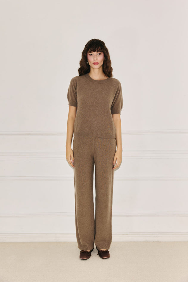 Woman wearing Enteliér taupe knit top