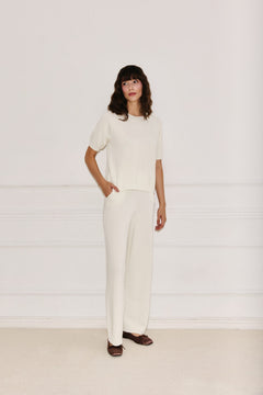 Woman wearing Enteliér ecru knit top