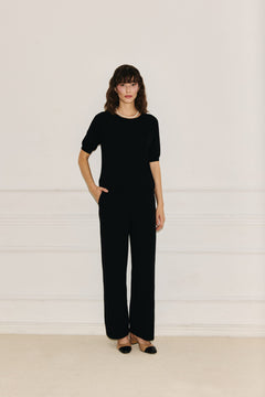 Woman wearing Enteliér black knit top