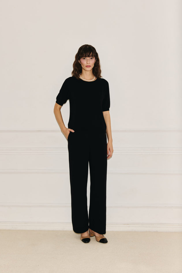 Woman wearing Enteliér black knit top
