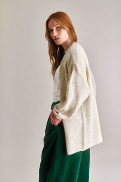 Woman wearing Komodo white lamb wool cardigan